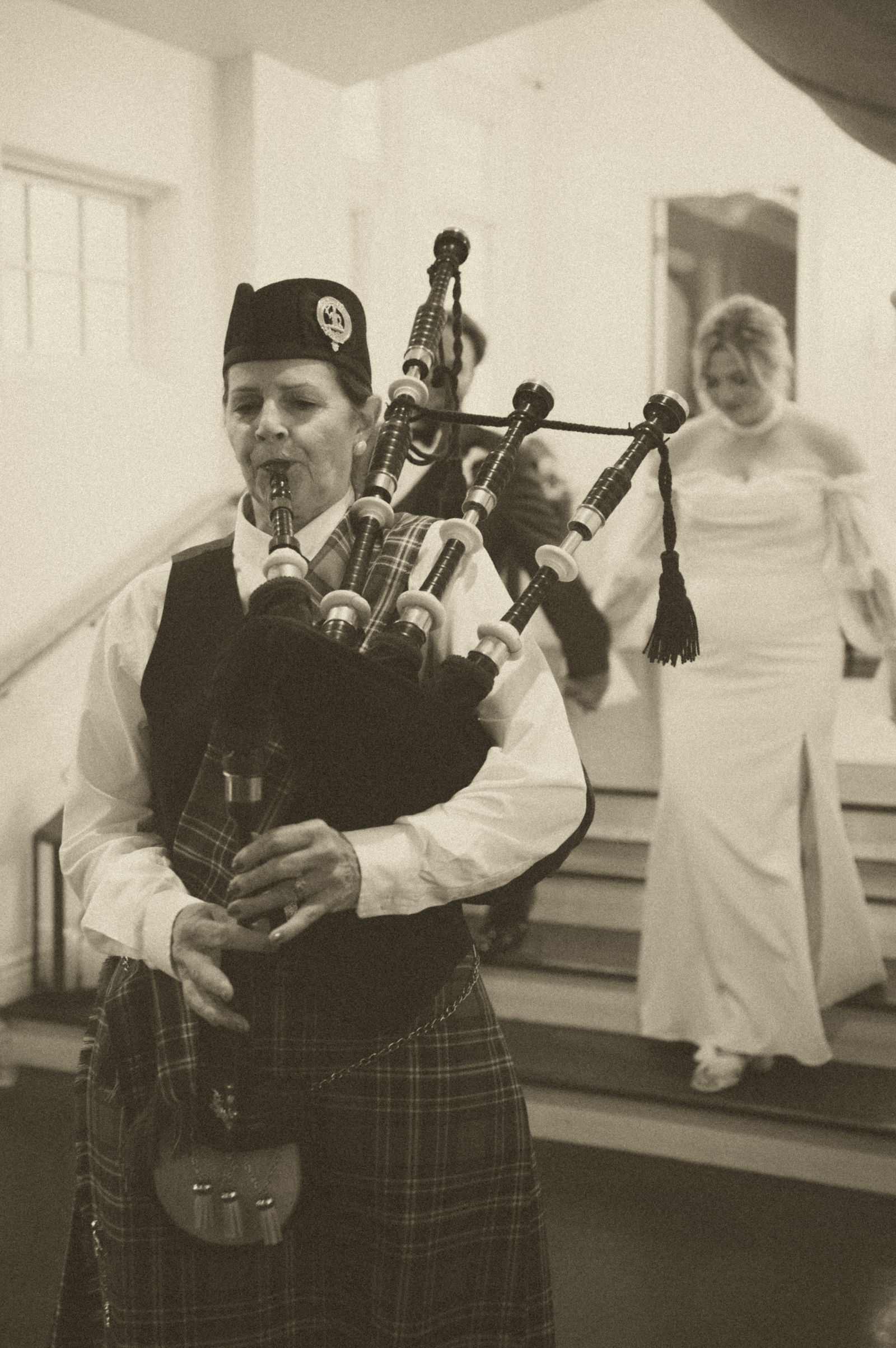 Piper in a kilt playing bagpipes at The Manor House Littleton