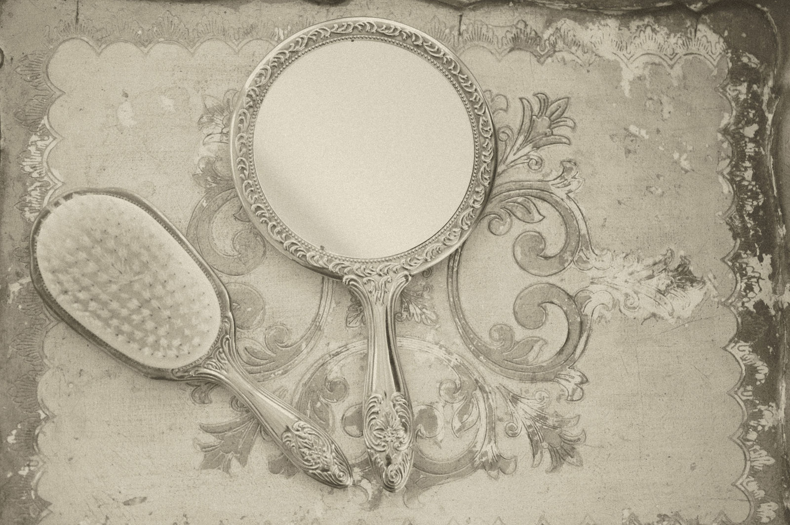 Ornate vintage hand mirror on a bridal suite table at The Manor House Littleton
