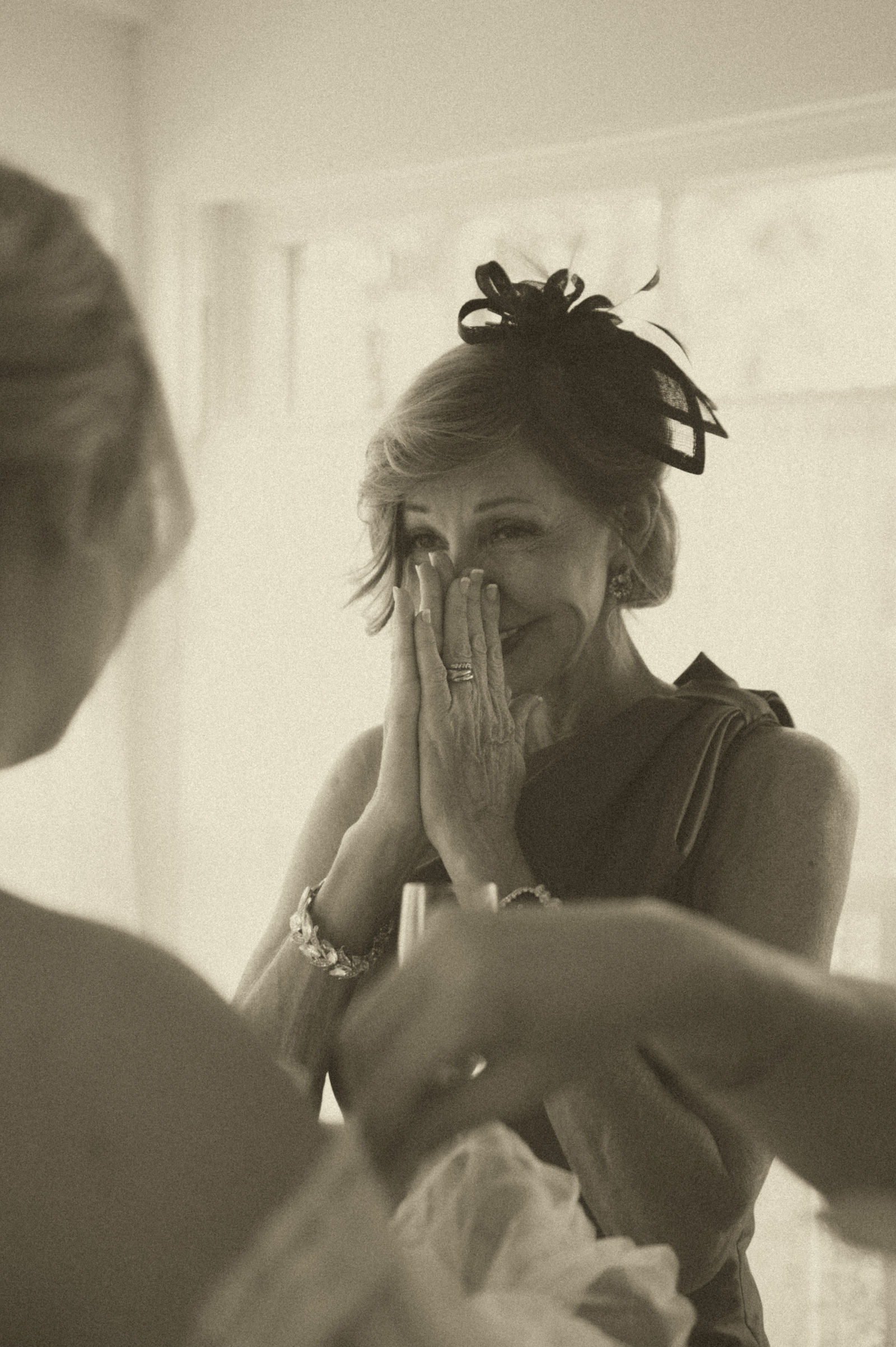 Mother of the bride covering her face during the first look with her daughter
