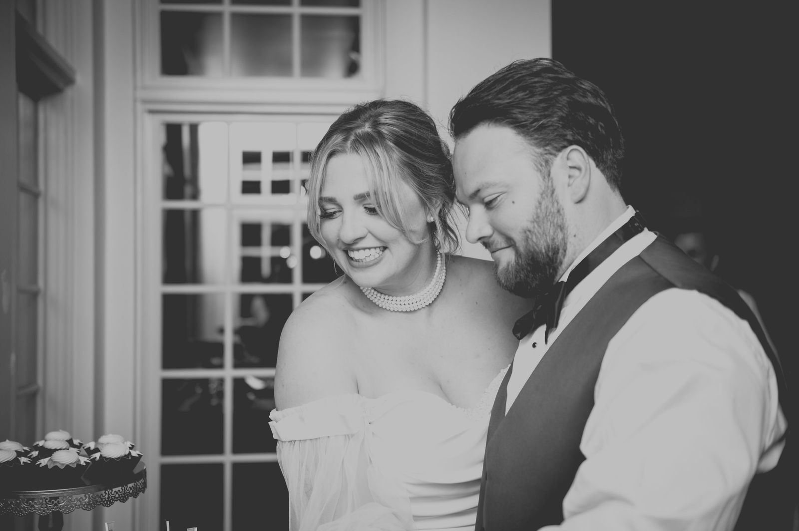 Bride and groom cutting the cake at The Manor House Littleton