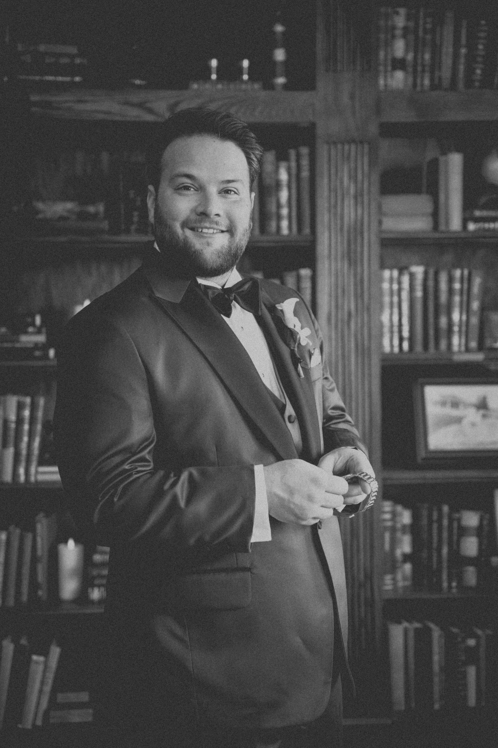 Groom portrait in a black tuxedo with an old Hollywood glamour edit