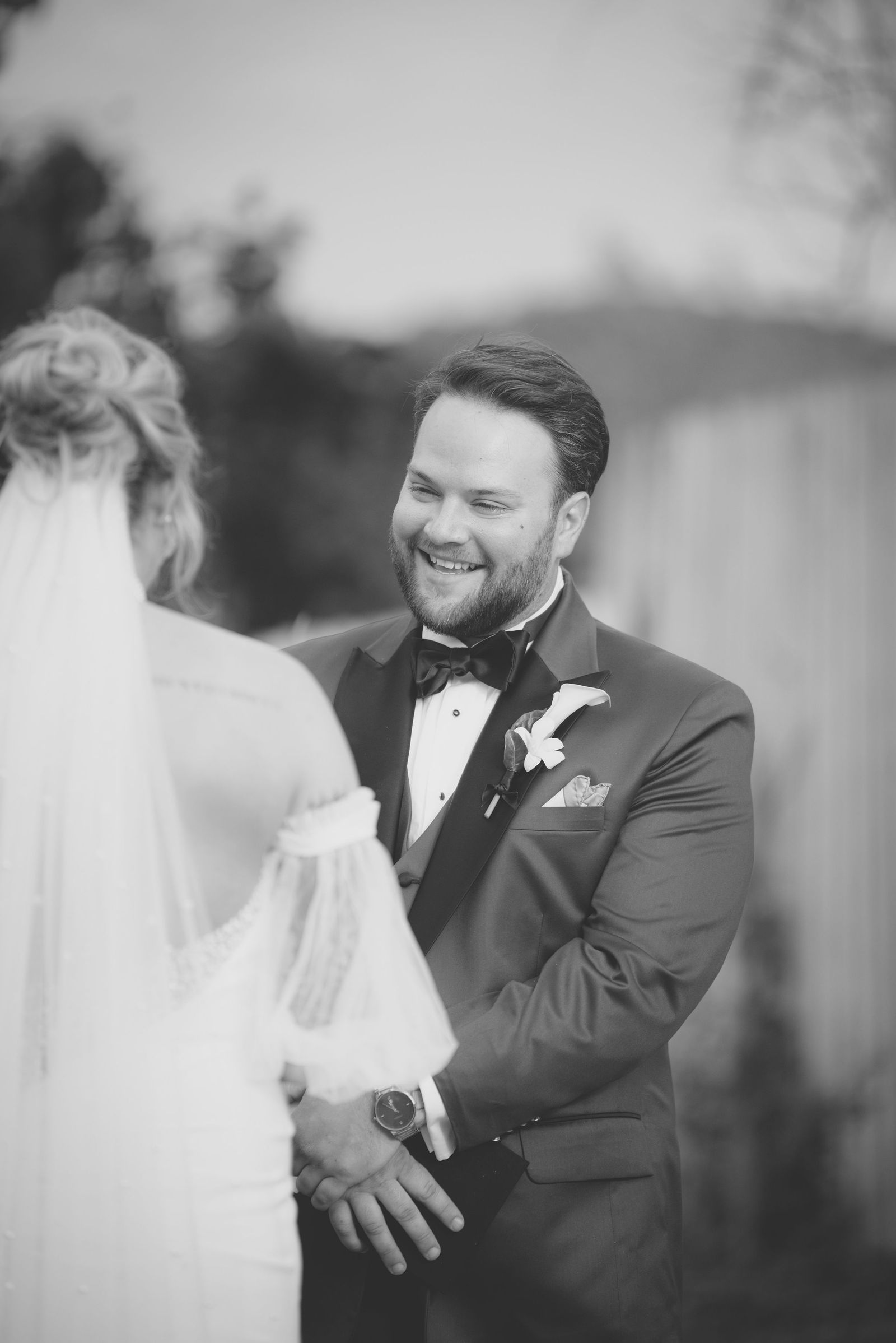 Groom smiling at his bride during the ceremony at The Manor House