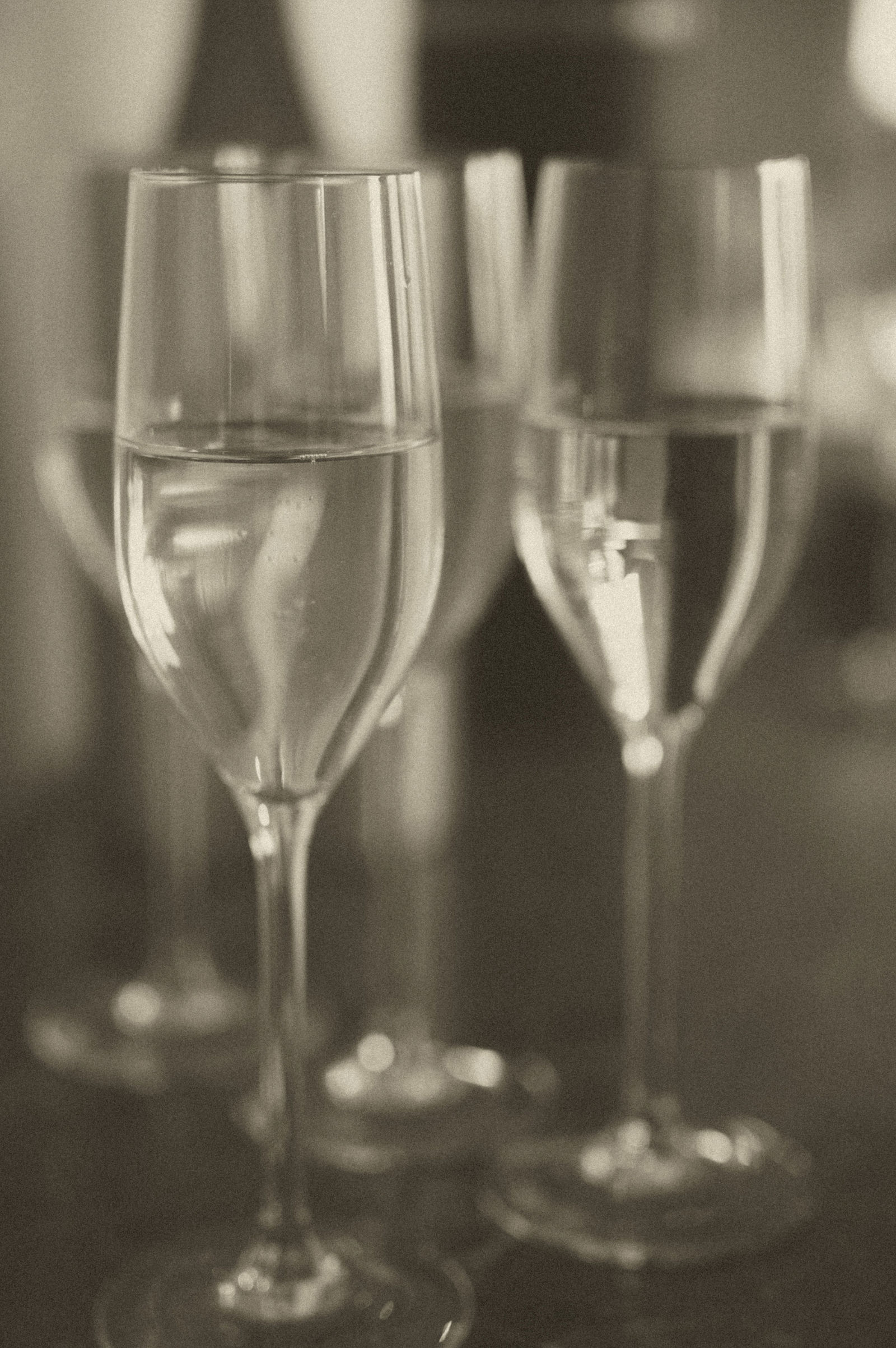 Coupe champagne glasses in the bridal suite photographed in sepia at The Manor House