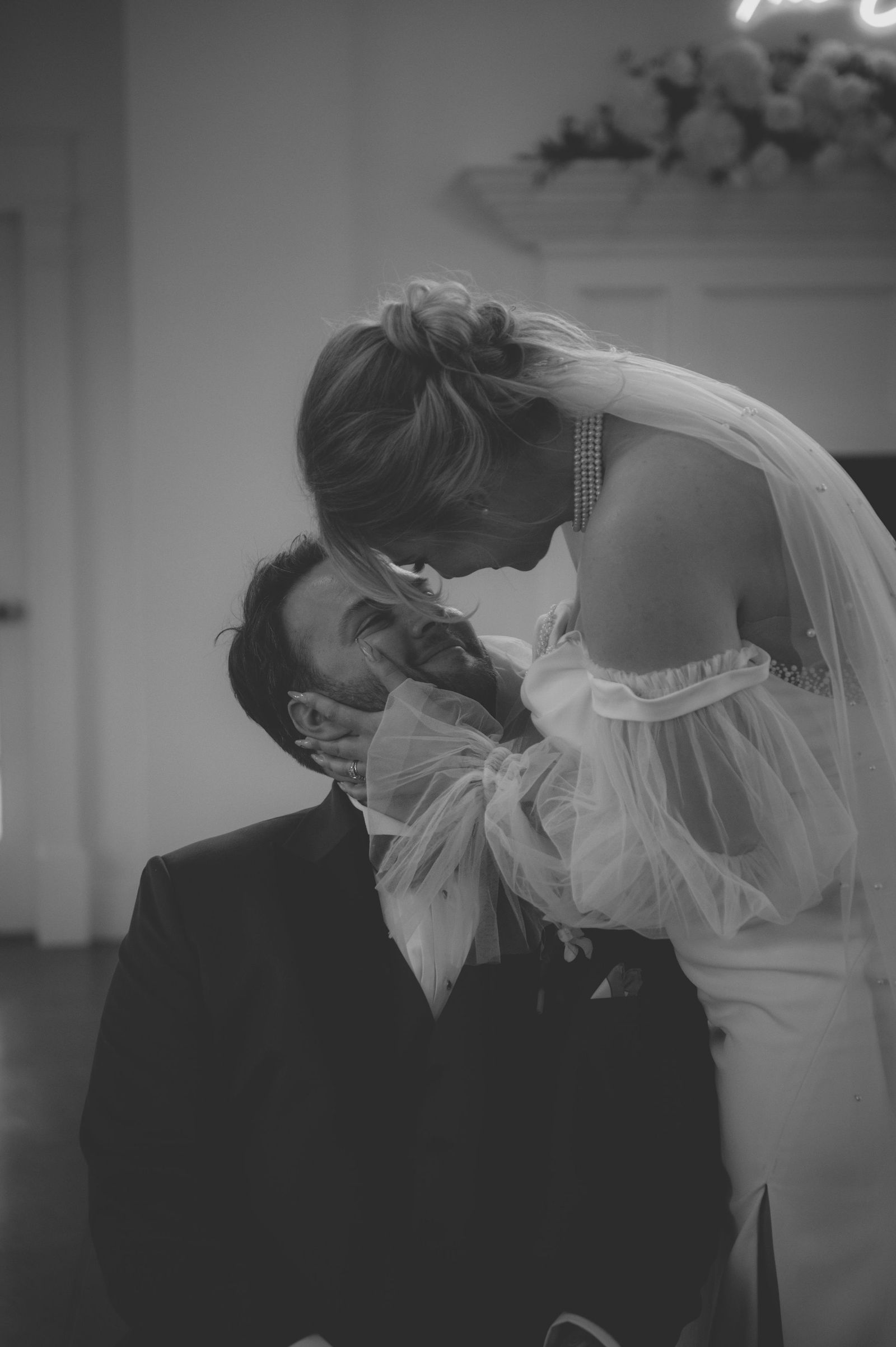 Bride and groom in a dramatic dip kiss on the Manor House lawn