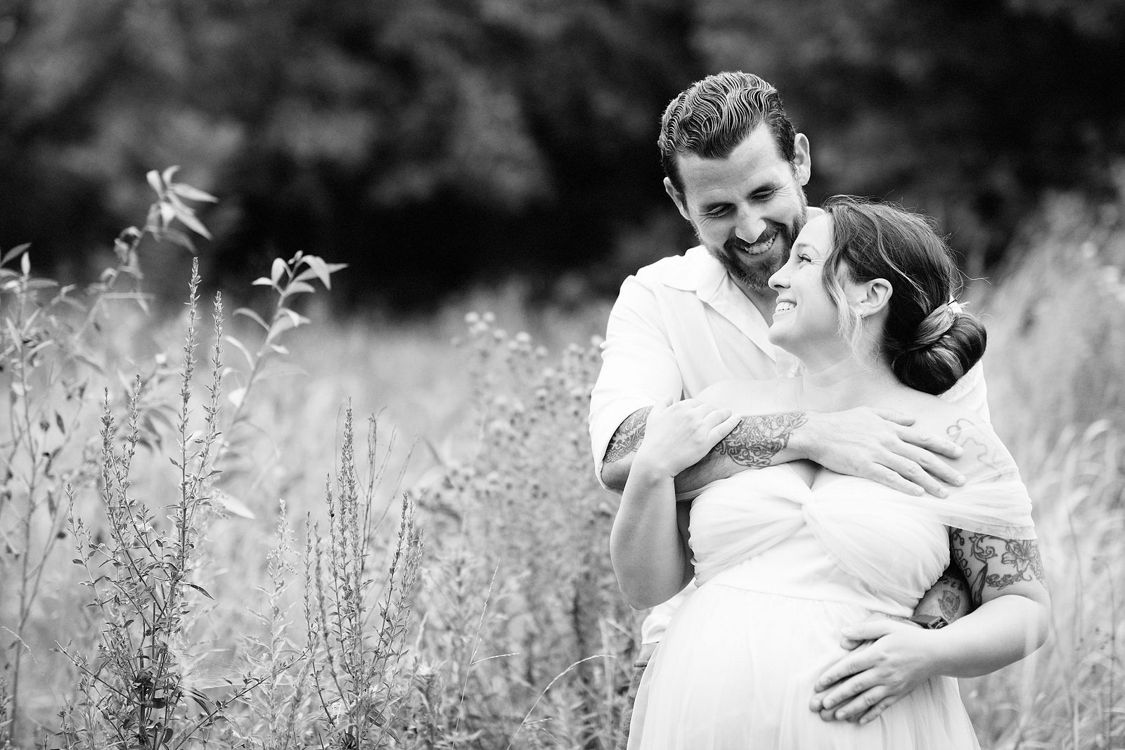 Black-and-white couple portrait in a meadow