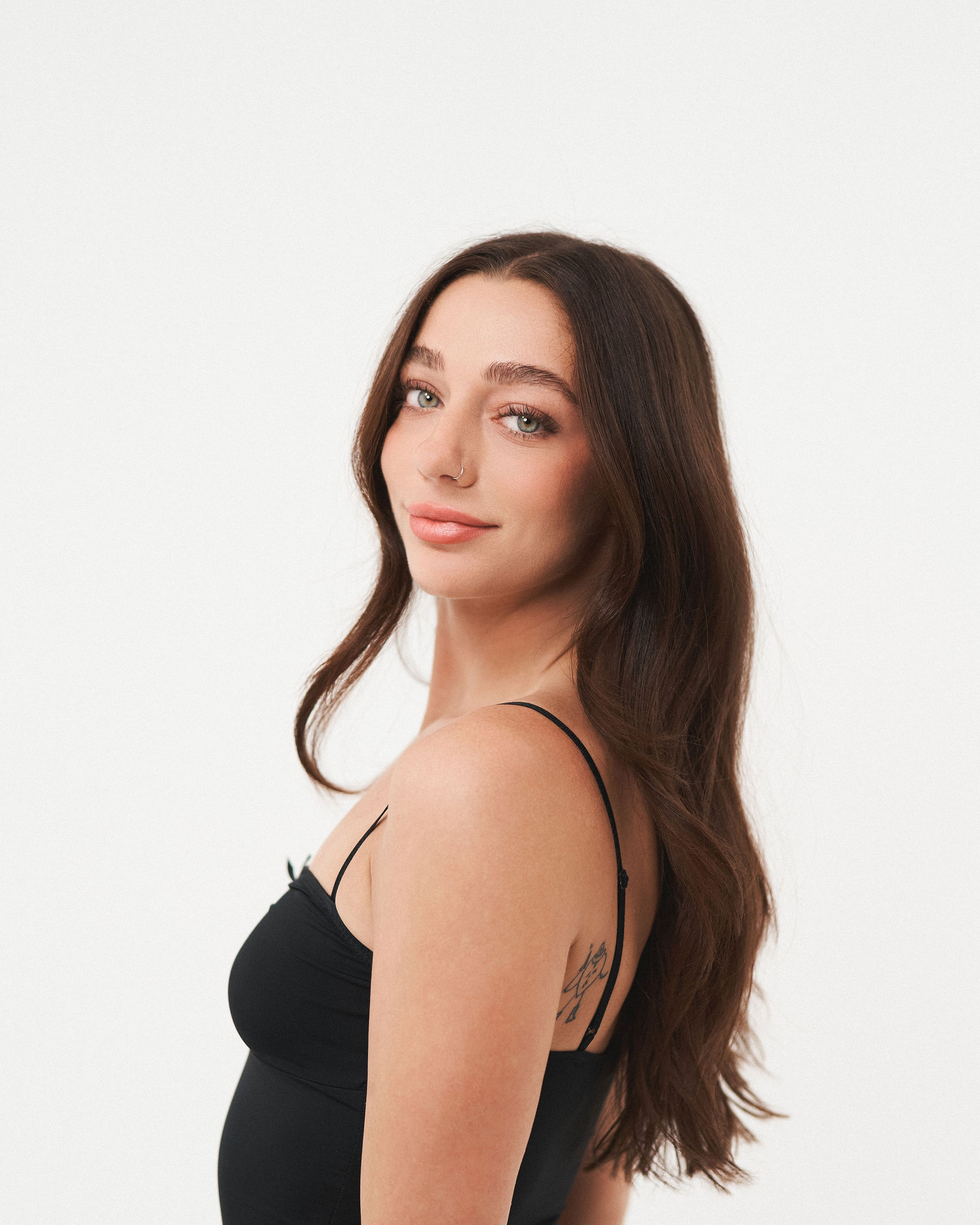 Professional portrait of a smiling woman on a white studio backdrop