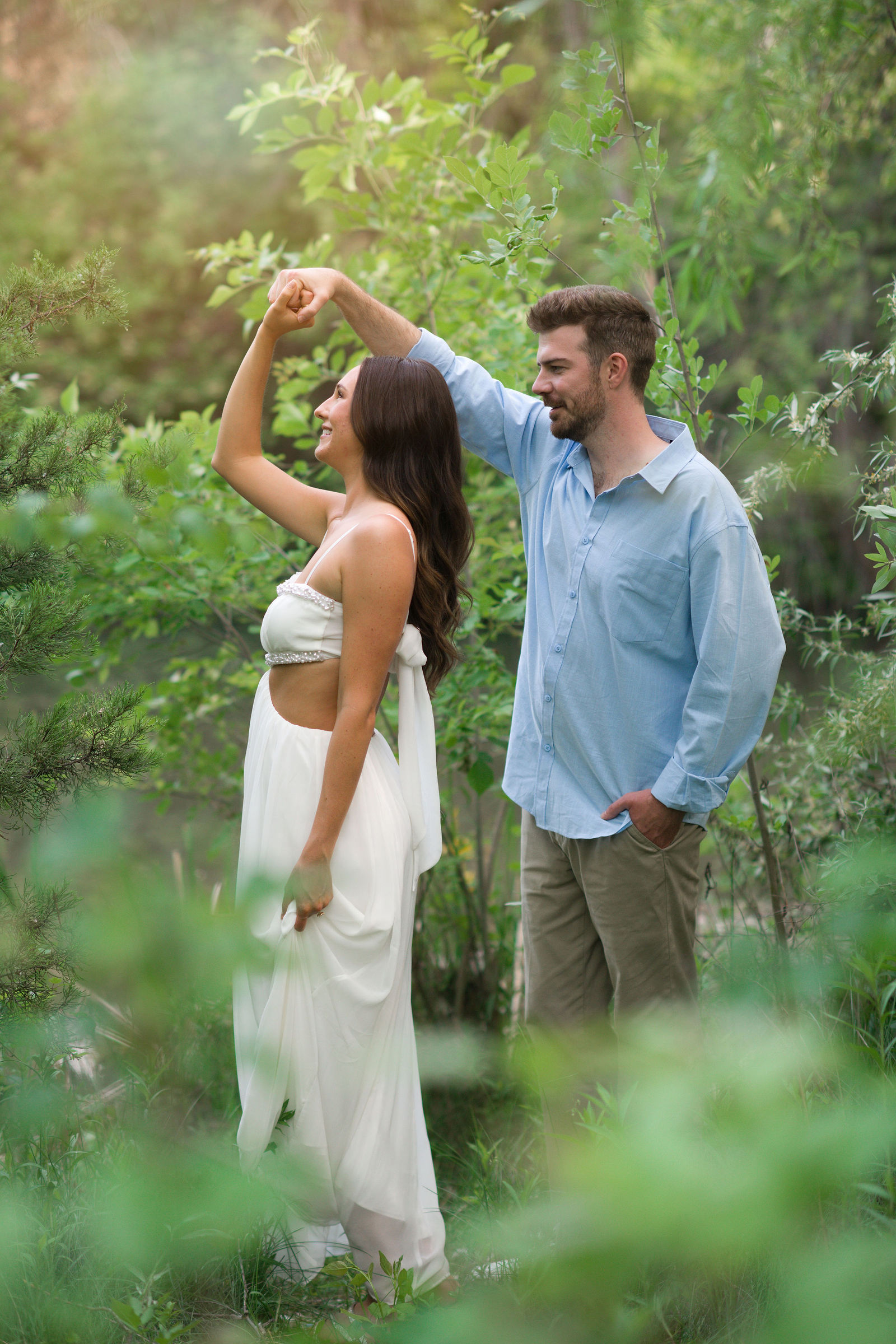 Couple dancing together among the greenery