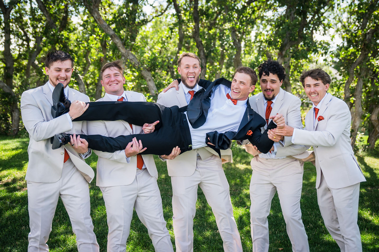 Groomsmen celebrating with the groom at a Colorado wedding