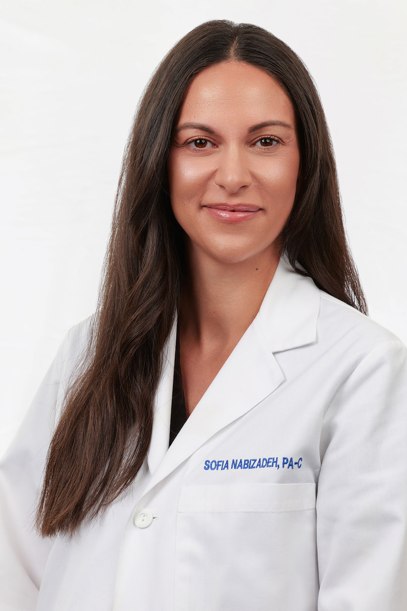 Studio headshot of a medical provider in a white coat