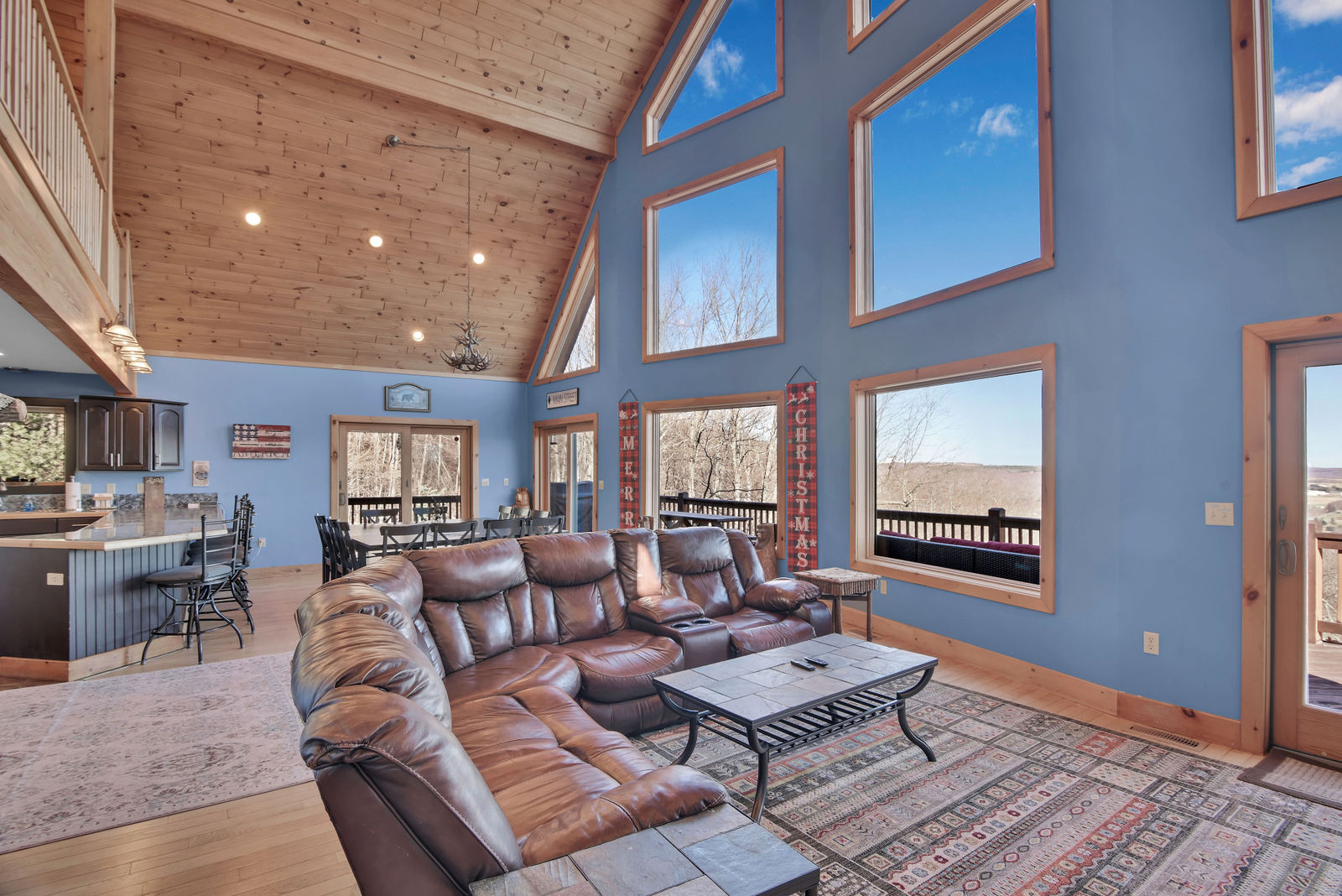 Vaulted great room with a wall of windows
