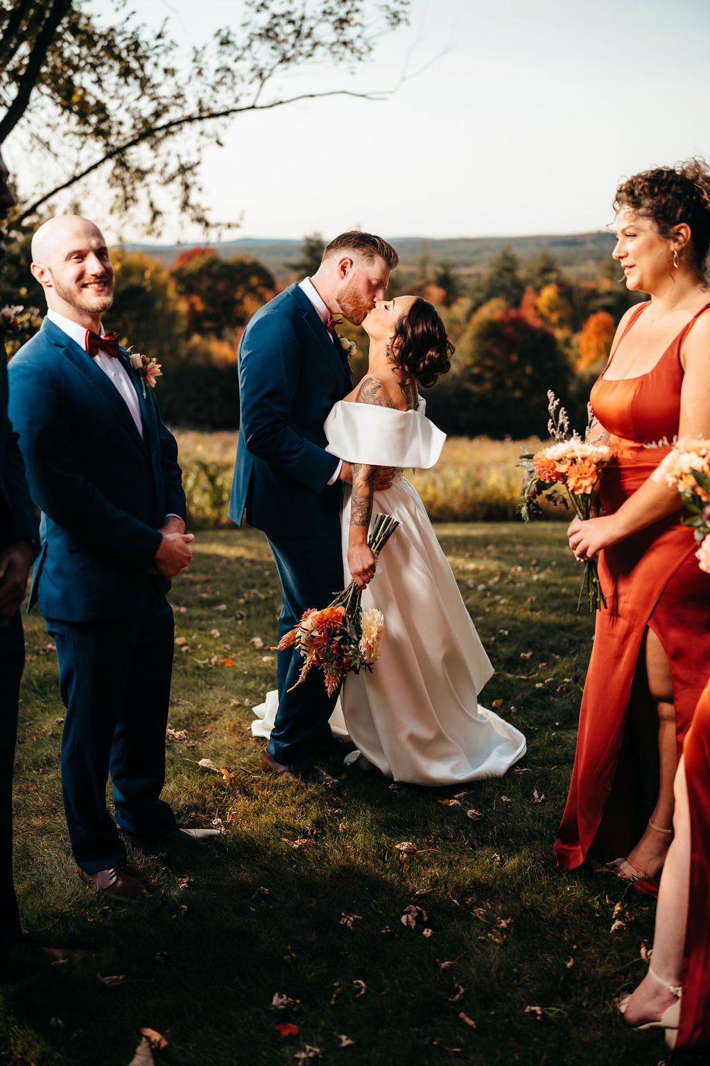 Samantha and McCallum kissing with autumn hills at sunset