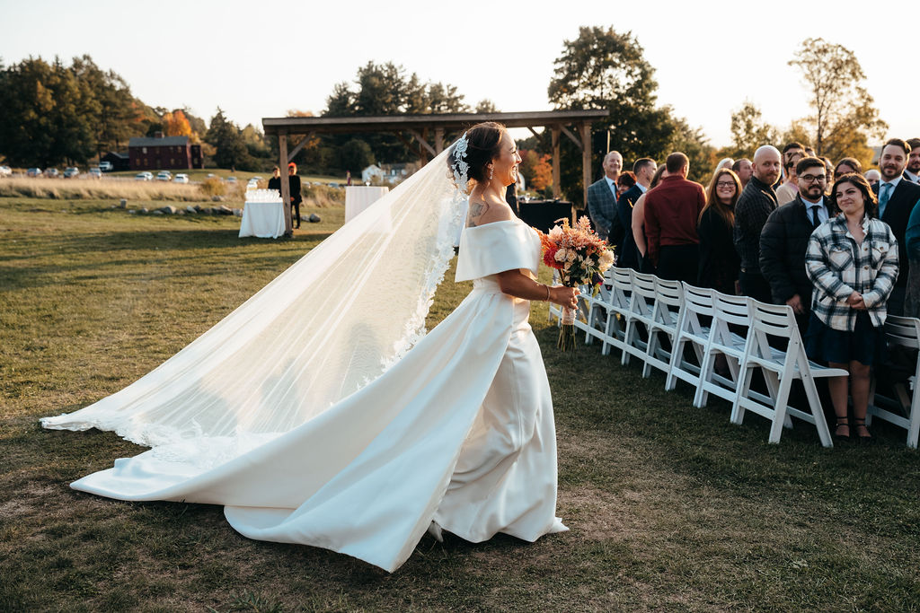 Samantha walking down the aisle, veil flowing