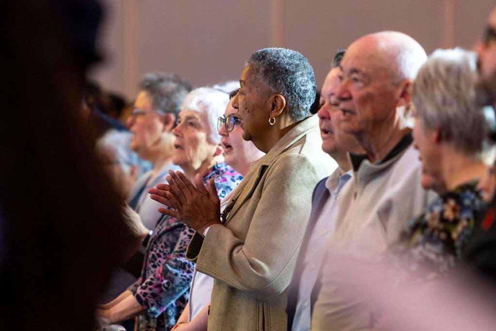 Guests clapping during worship