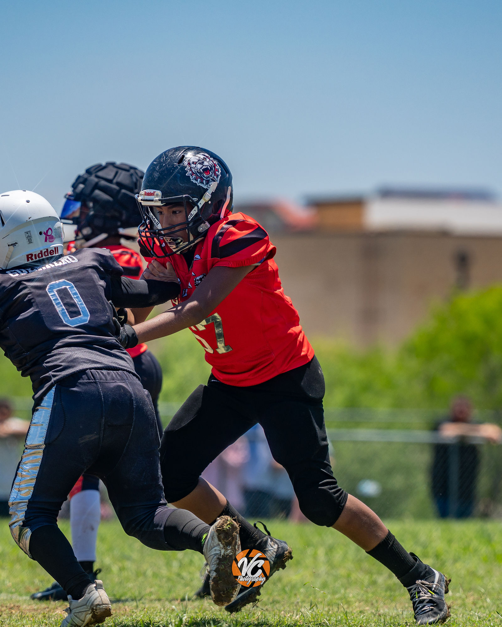 Bulldogs 10U football action photography by Austin sports photographer VC Photography
