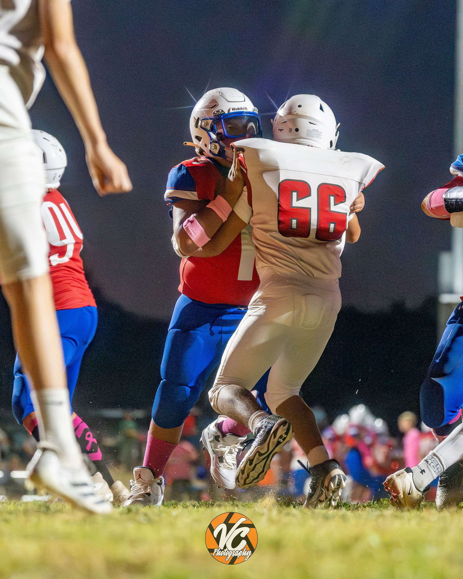 Barton Bobcats football player driving forward during a physical play against Dahlstrom Middle School