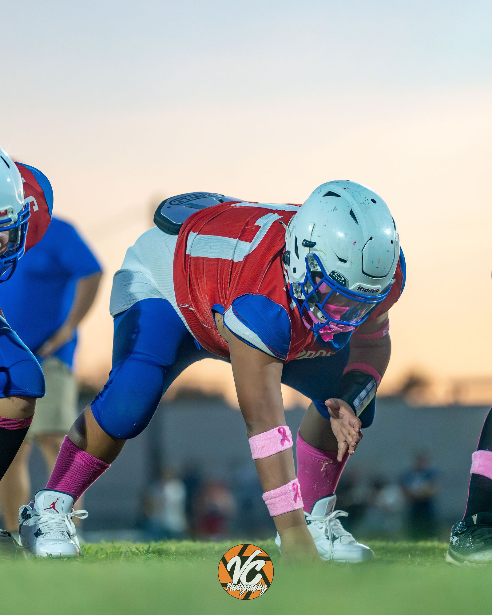 Barton Middle School Bobcats football players walking together beneath a dramatic Central Texas sunset