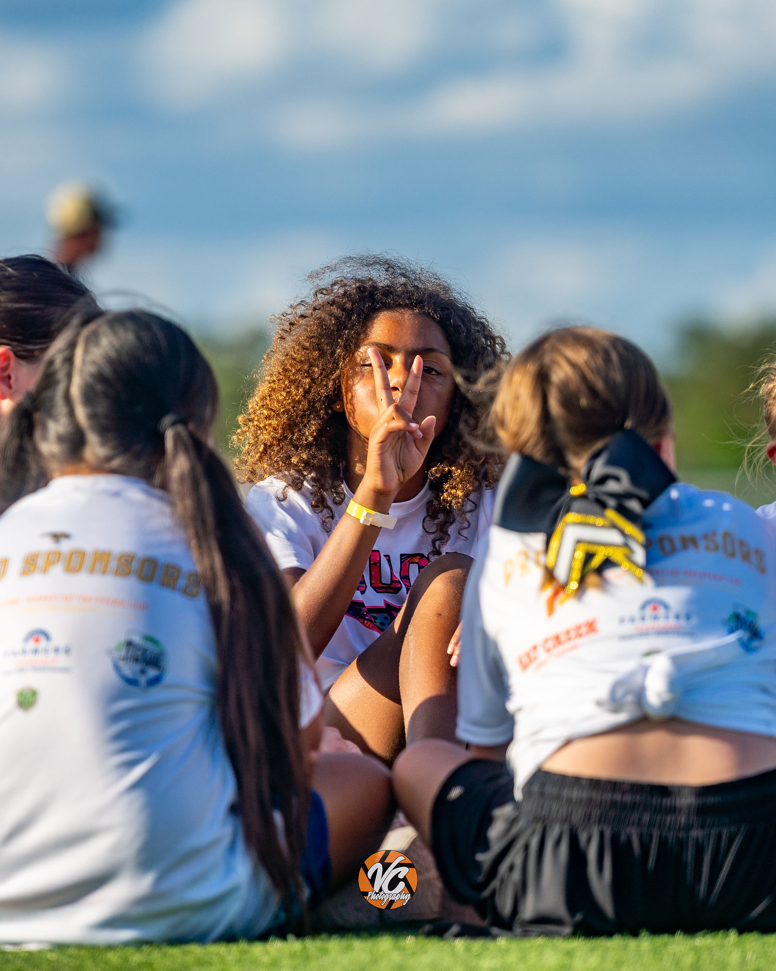 Buda youth football camp athlete reaction and team action photo