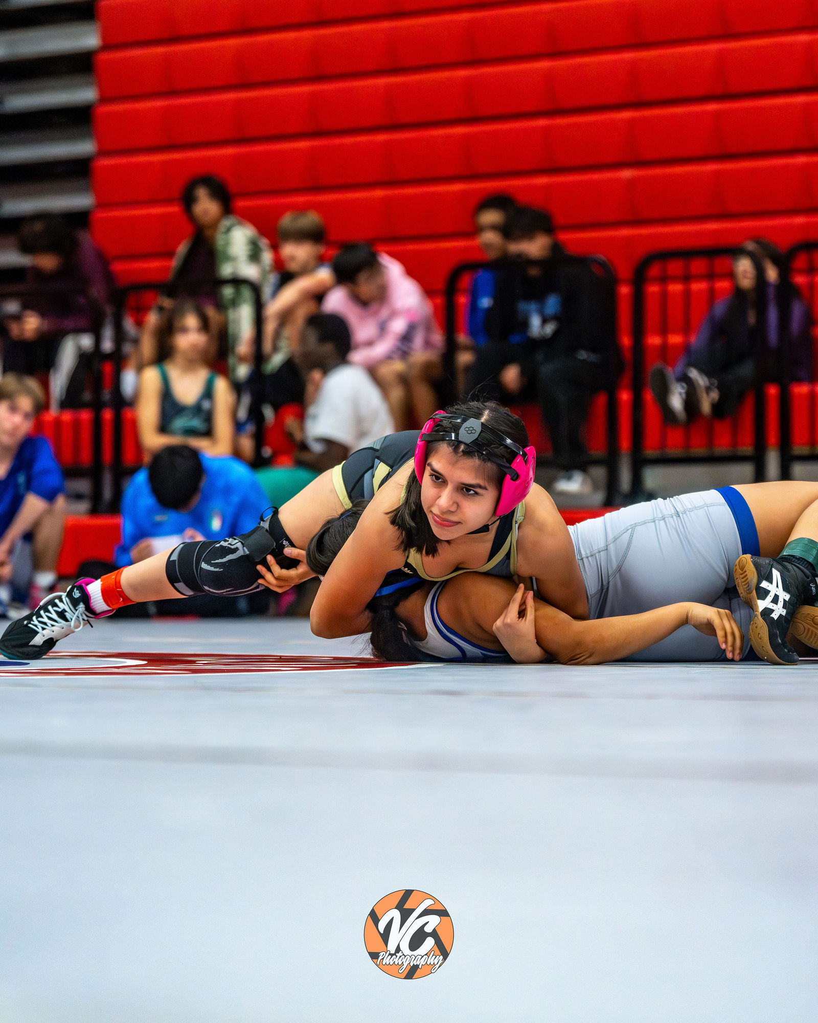 Buda sports photographer documenting Johnson wrestling movement and intensity