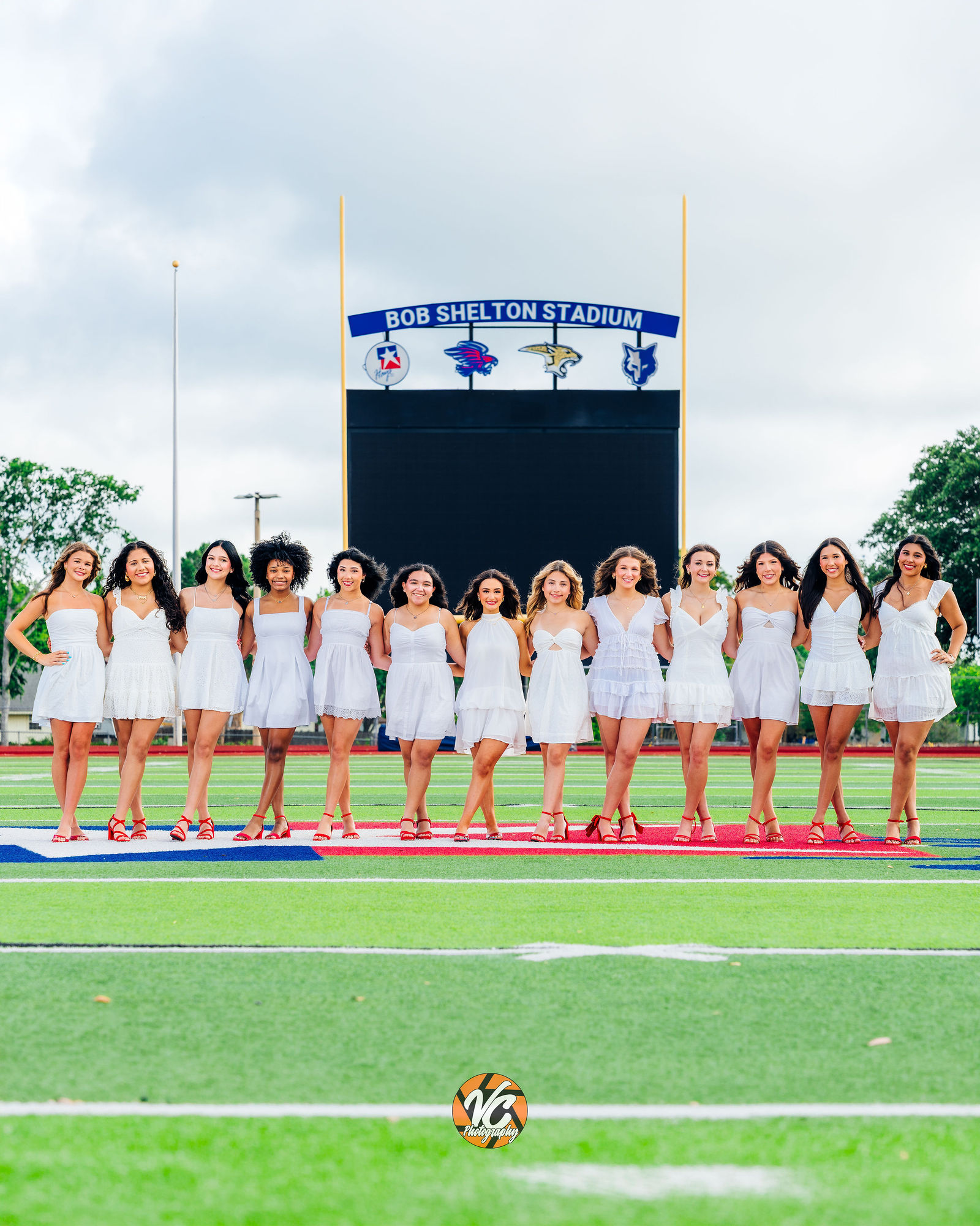 Hays High School cheer seniors posing together during a cinematic senior portrait session
