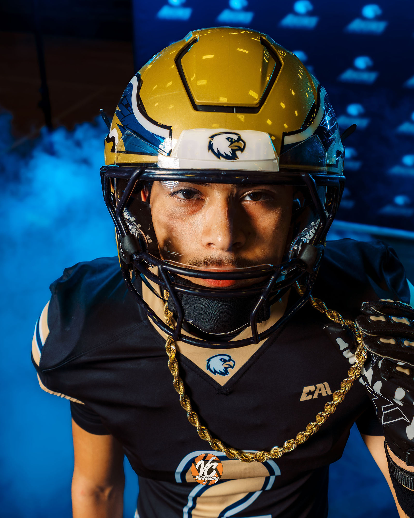 Akins High School football player photographed with cinematic media day lighting in Austin Texas