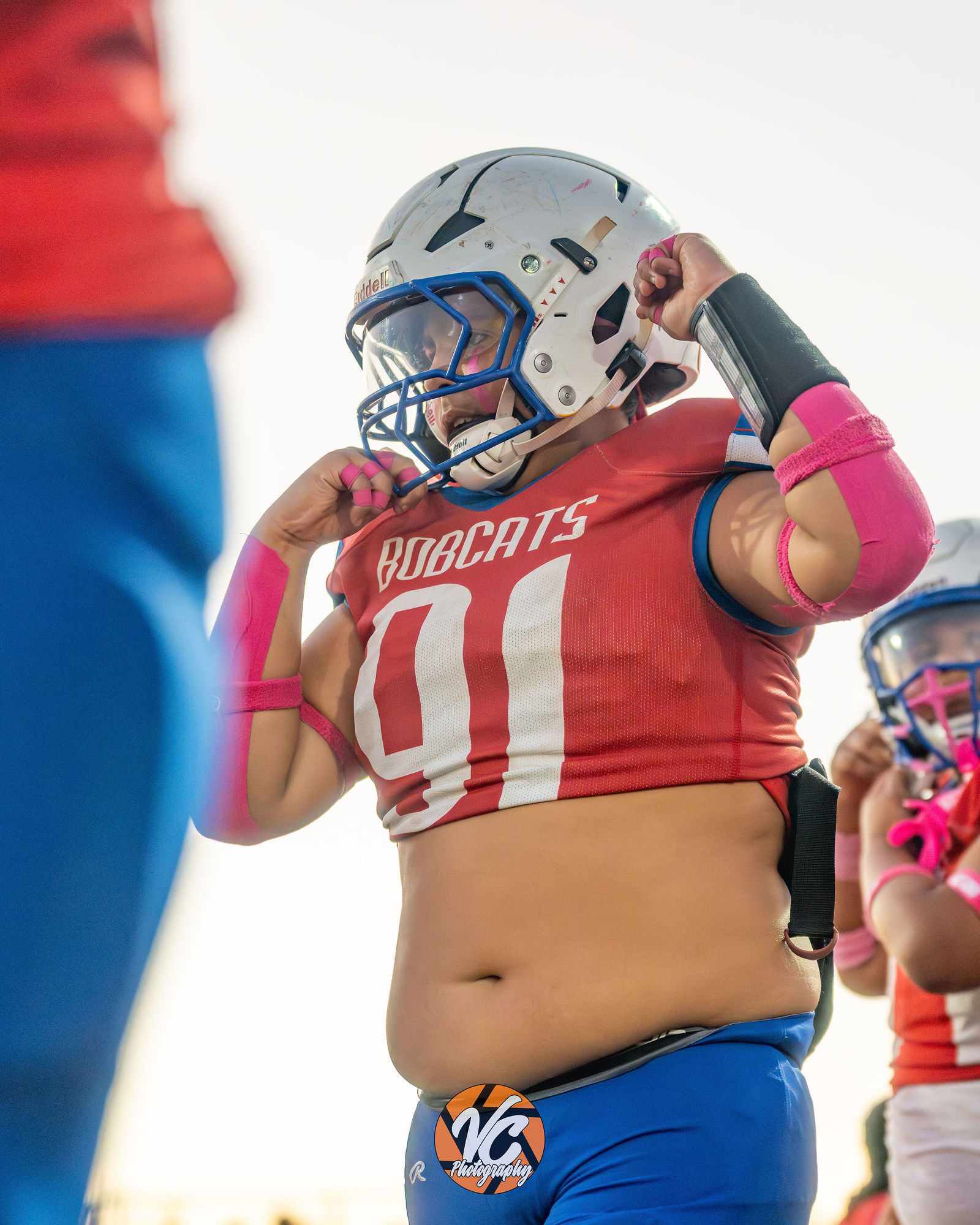 Barton Bobcats football player engaging a Dahlstrom Middle School defender during live action in Buda