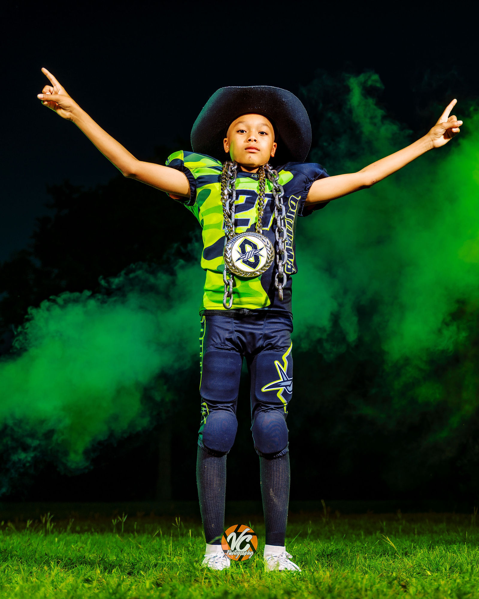 Hays Outlaws youth football athlete holding the team flag during a cinematic portrait session at Stagecoach Park in Buda