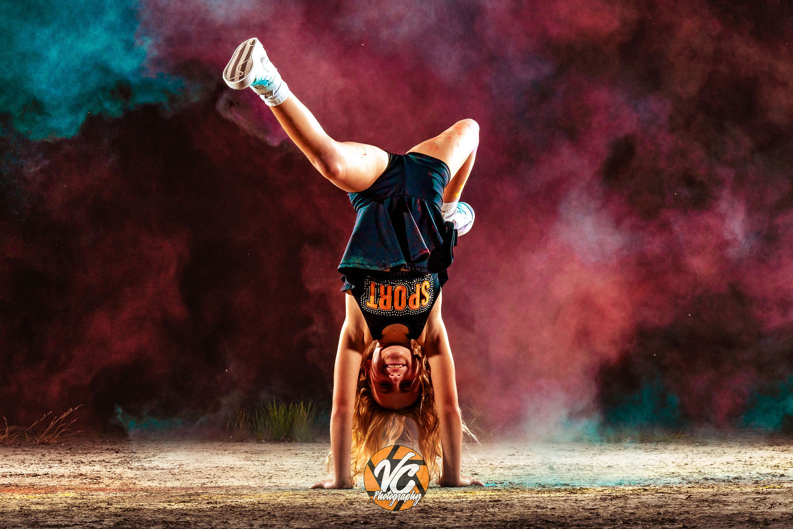 Austin sports photographer cheer athlete branding image with colorful powder and cinematic editing