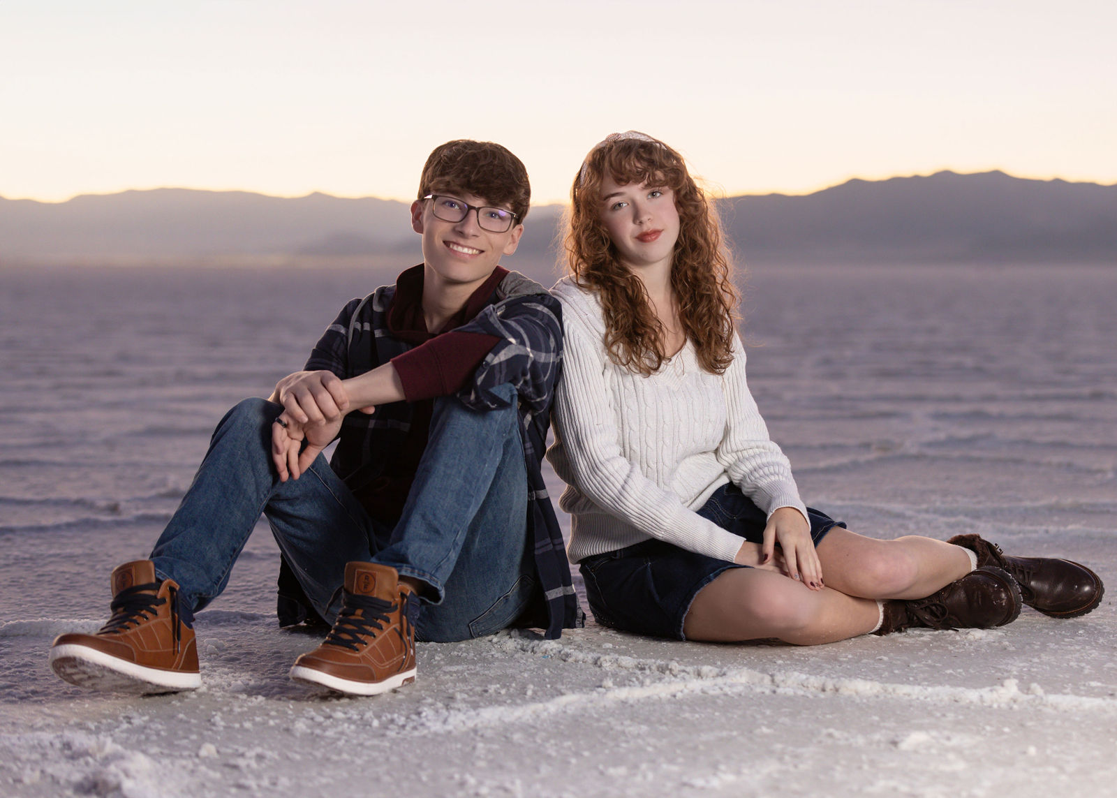 Senior portrait of Nathan at the Bonneville Salt Flats in Utah with wide open white landscape