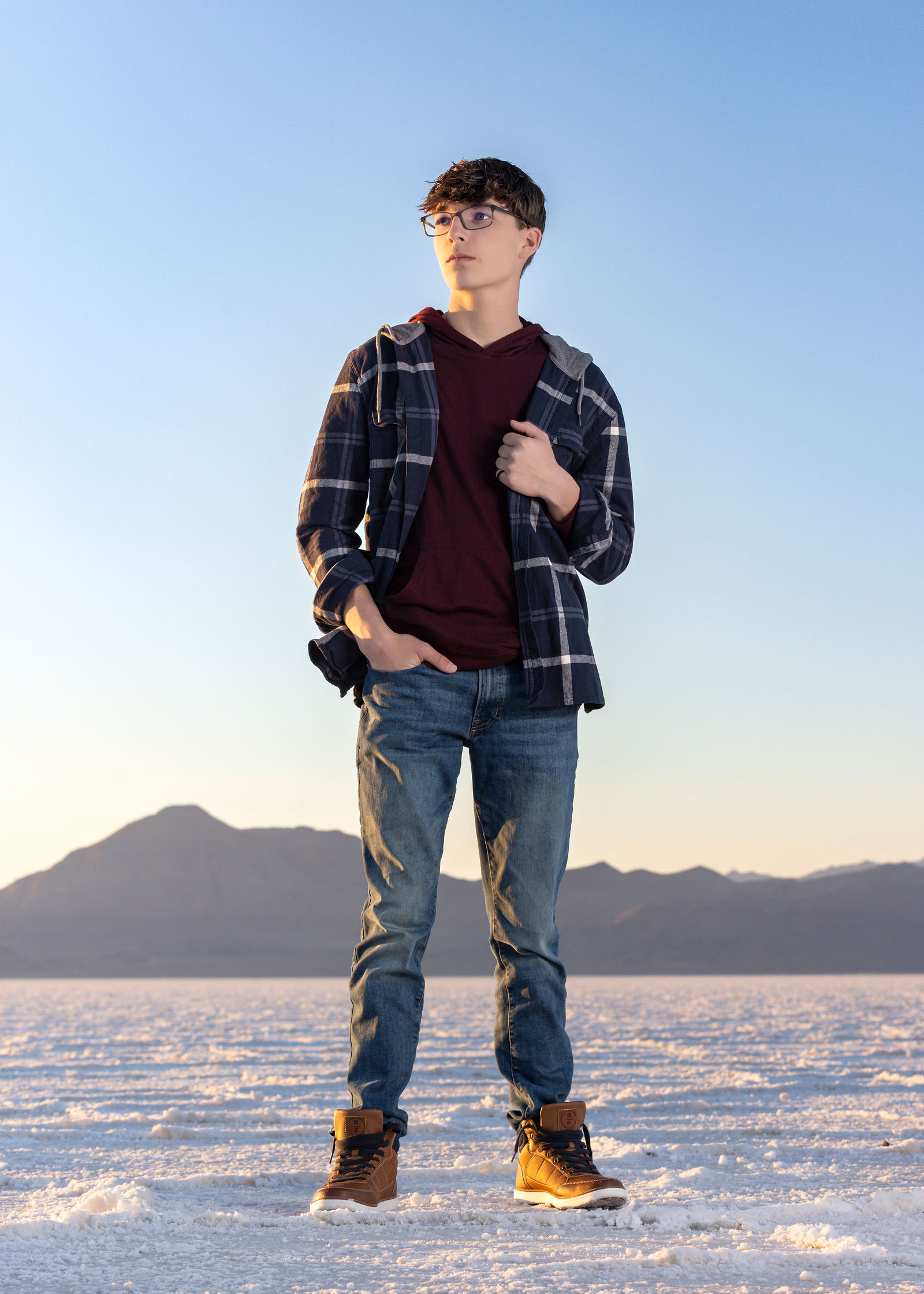 Senior portrait at Bonneville Salt Flats showing wide open space and minimalist editorial style