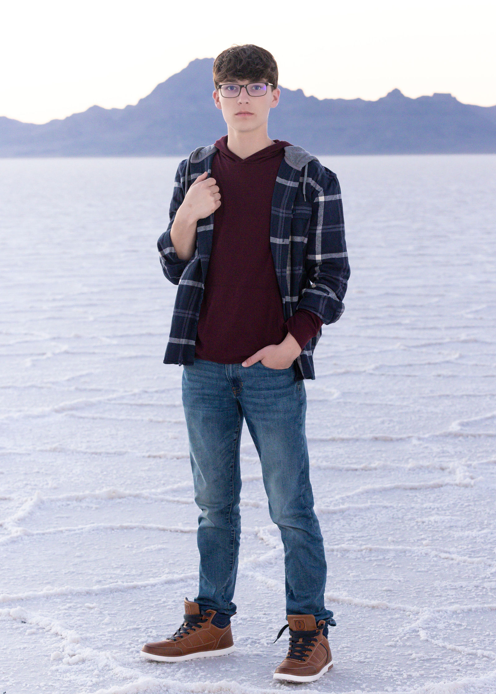 Nathan posing for senior pictures at Bonneville Salt Flats with editorial styling