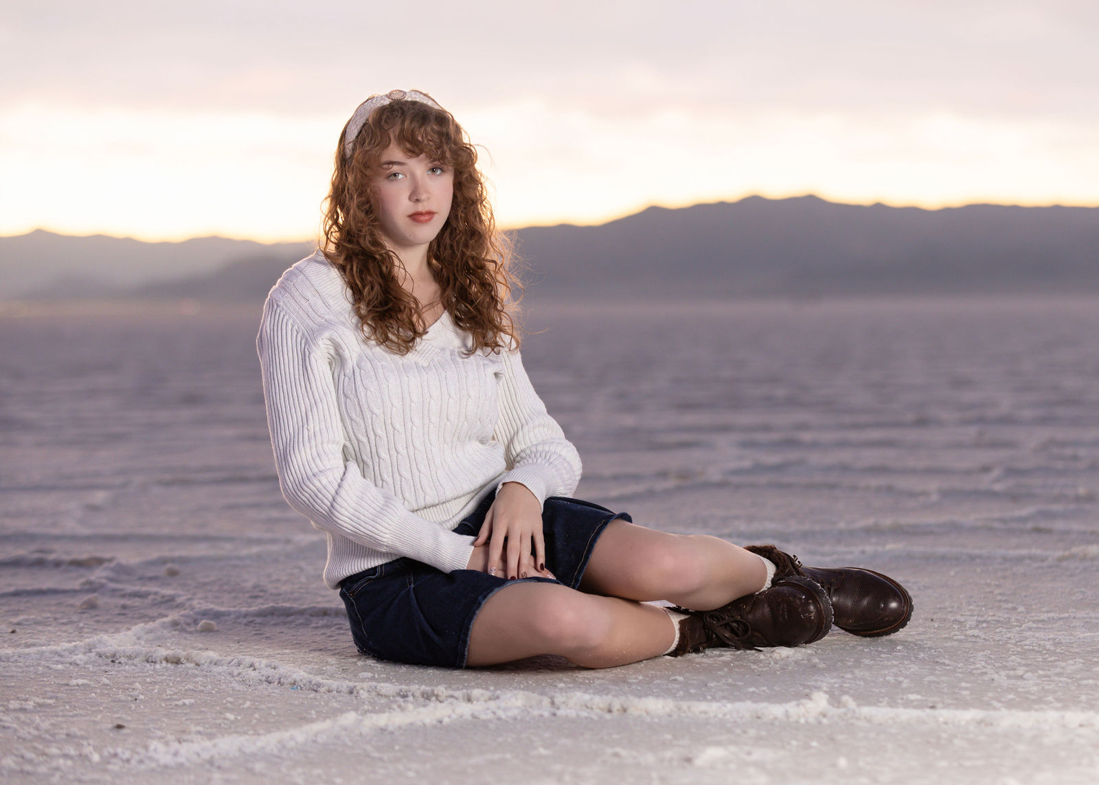 Senior photo at Salt Flats showing reflective ground and expansive sky