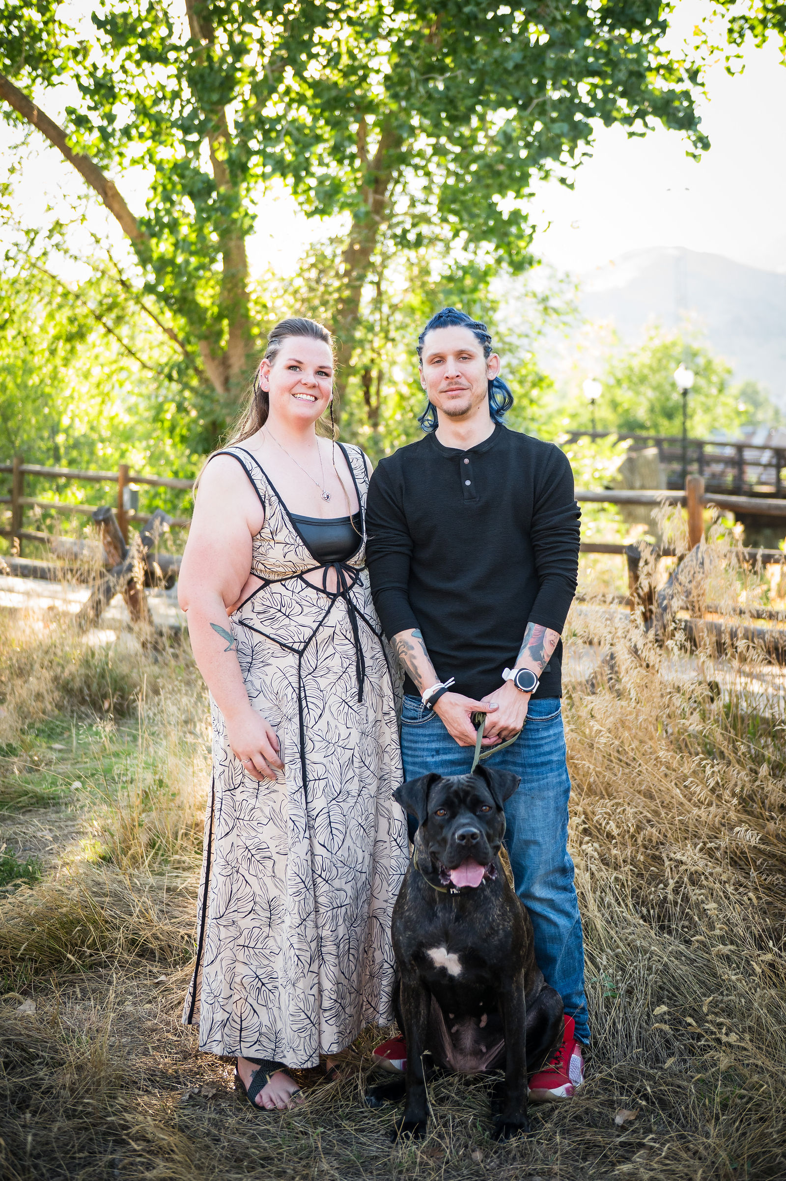 Couple with the woman in a printed maxi dress and the man in a black henley during a Colorado engagement session