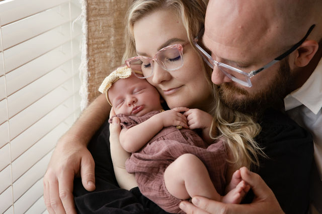 Utah County in-home newborn photographer capturing a softly posed newborn portrait on a neutral setup
