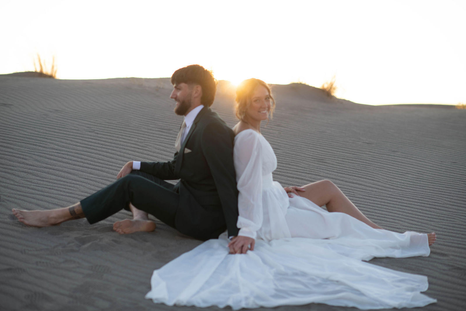 Taya and Casper together on the sand dunes at sunset