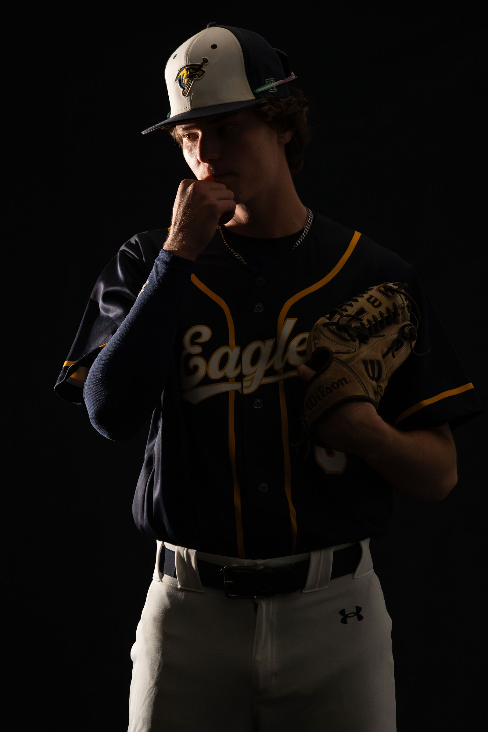 Baseball senior, Eagles uniform, dramatic studio lighting
