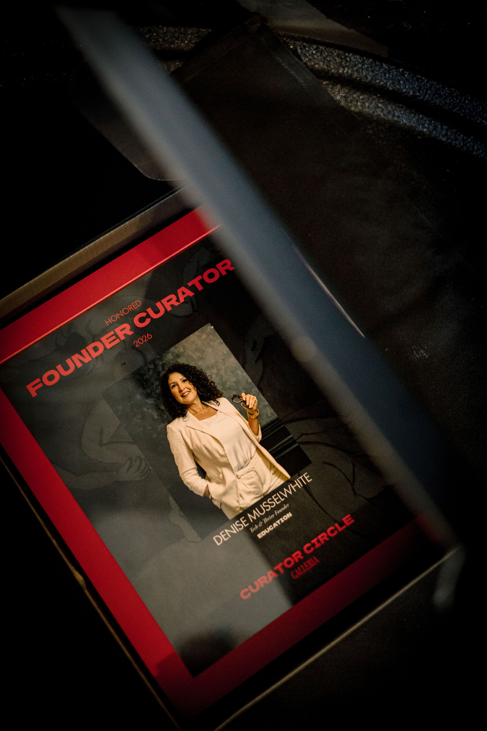 Denise Musselwhite's Founder Curator plaque, face up in its black box.