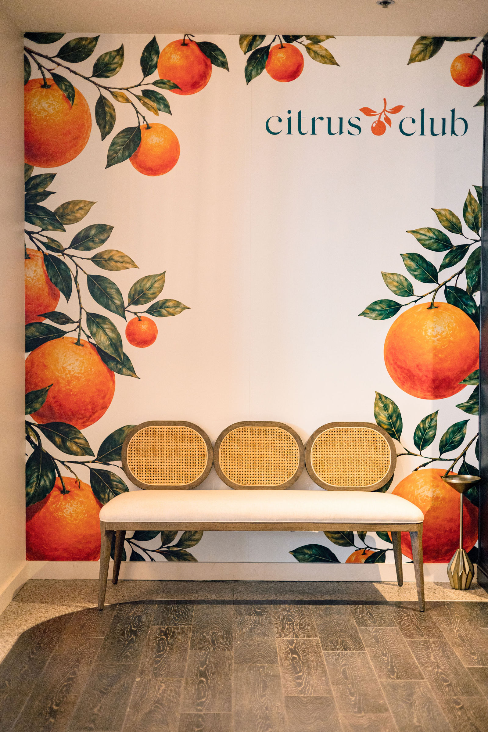The Citrus Club's orange-print wall and bench, before the room filled.