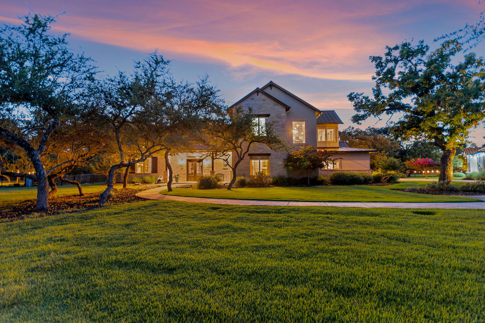 Front exterior view of 55 Brook Ridge, Fair Oaks Ranch, TX, showcasing the beautiful landscaping and large yard.