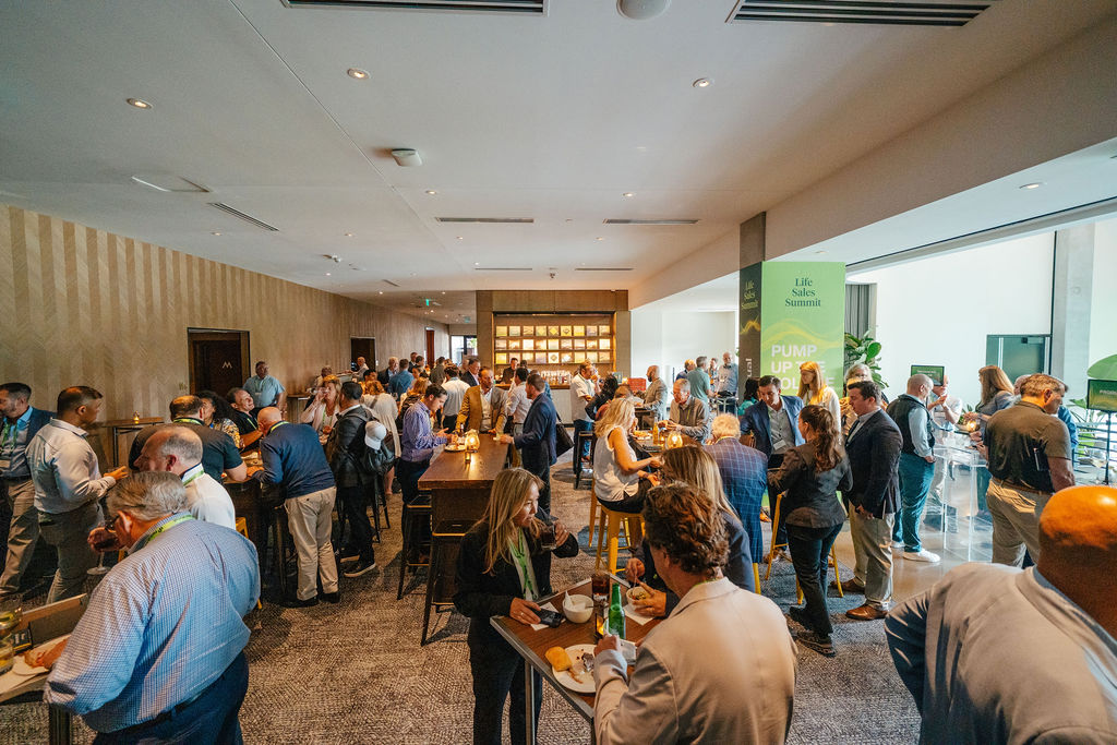 Convention attendees networking and mingling during a break at a Nashville corporate summit