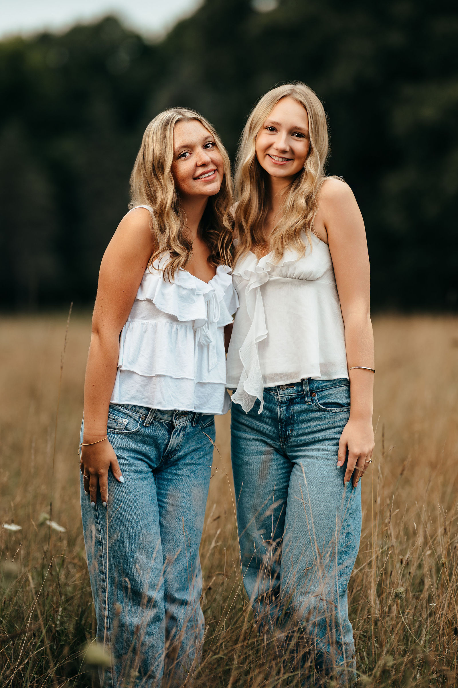 Aly and Syd together in a field during their senior portrait sessions