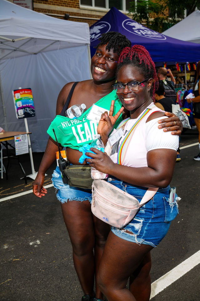 Two women at the She & HER booth at NYC Pride