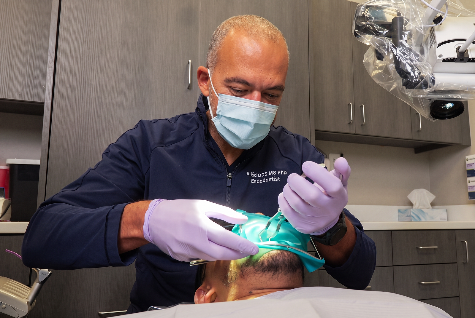 Oral surgeon working with a surgical microscope