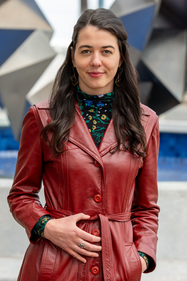 Headshot of a woman in a red leather jacket, photographed by Dodi Images
