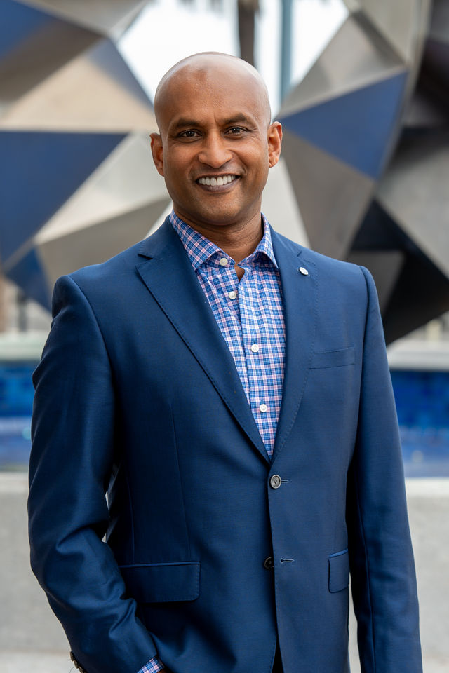 Executive headshot of a man in a blue suit, photographed by Dodi Images