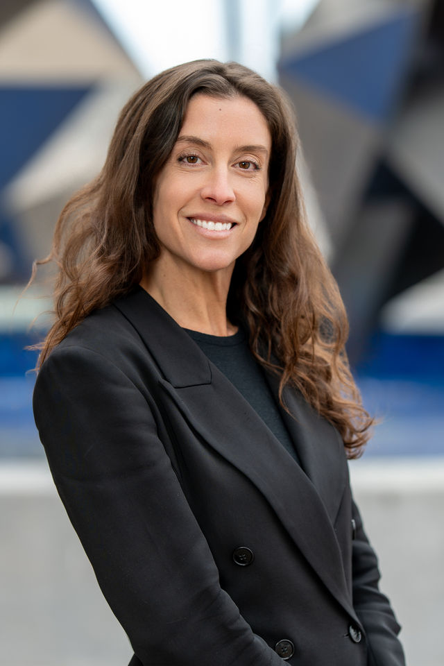 Conference headshot of a woman in a black blazer, photographed by Dodi Images