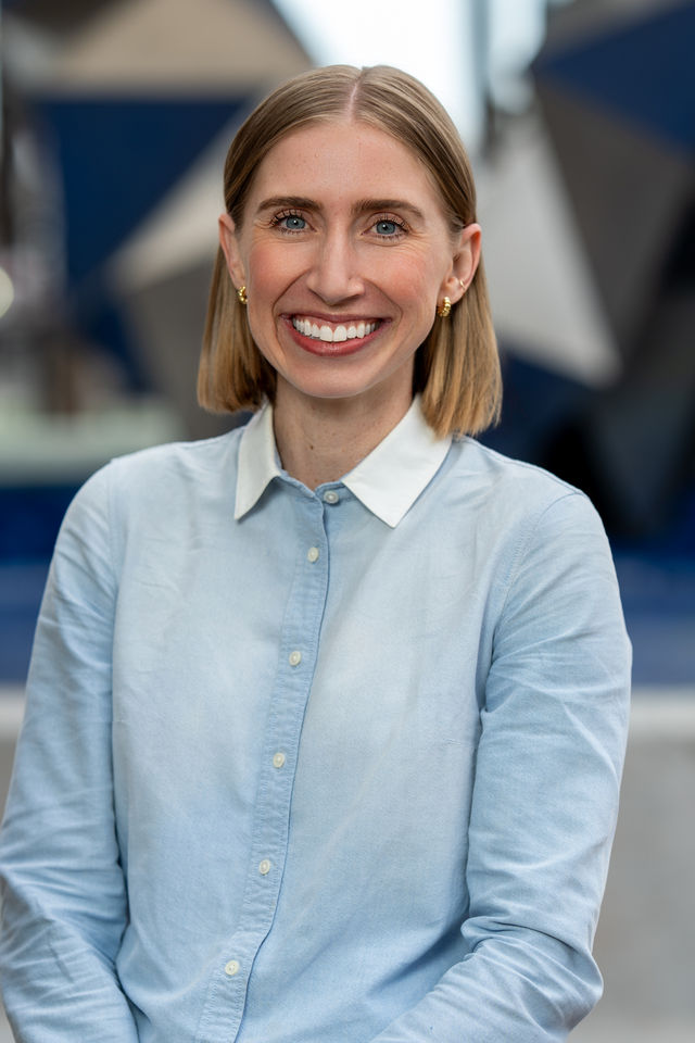 Headshot of a woman in a light blue shirt, photographed by Dodi Images