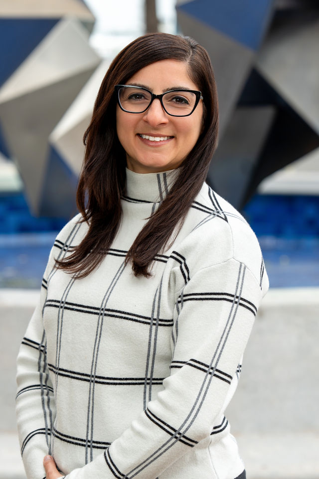 Headshot of a woman in a checked sweater, photographed by Dodi Images