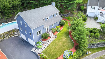 Aerial drone photo of a home's lot and surrounding trees