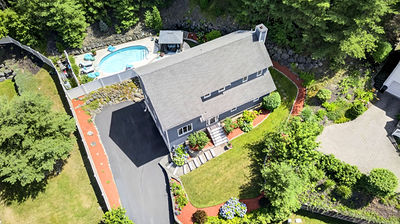 Aerial drone photo showing a backyard pool and landscaping