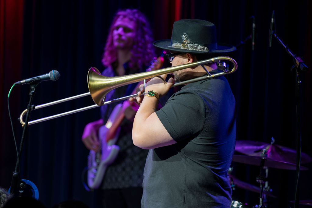 Haley Reinhart performing in front of the Middle C Jazz sign